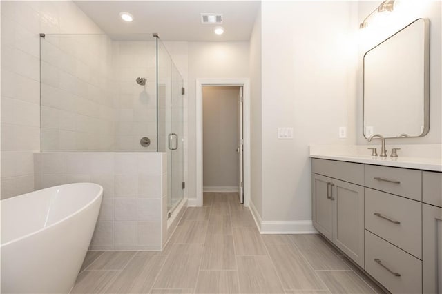 bathroom featuring plus walk in shower and vanity