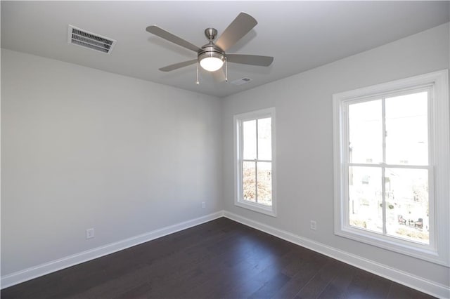 empty room featuring dark hardwood / wood-style flooring and ceiling fan