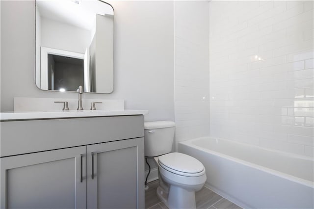 full bathroom with washtub / shower combination, hardwood / wood-style floors, vanity, and toilet