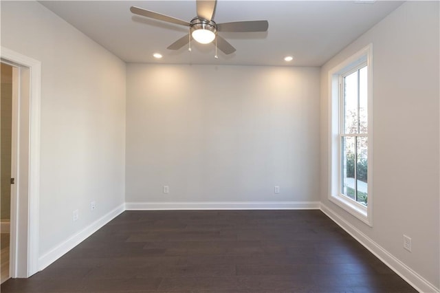 empty room with ceiling fan and dark wood-type flooring