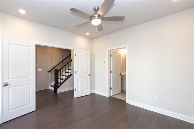 spare room featuring dark hardwood / wood-style flooring and ceiling fan