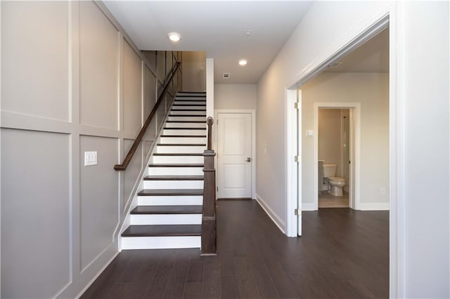 stairway featuring wood-type flooring