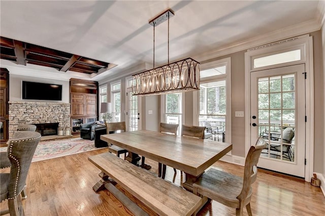 10020 Normandy Ln, Suwanee, GA 30024 - dining room featuring light wood-style floors, crown molding, coffered ceiling, a stone fireplace, and beamed ceiling