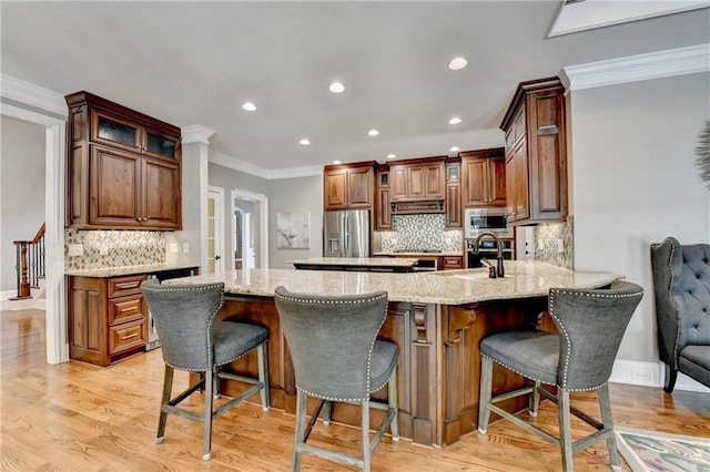 10020 Normandy Ln, Suwanee, GA 30024 - kitchen featuring stainless steel appliances, crown molding, a peninsula, tasteful backsplash, and recessed lighting