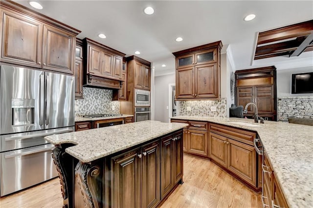 10020 Normandy Ln, Suwanee, GA 30024 - kitchen featuring appliances with stainless steel finishes, backsplash, light wood-style floors, recessed lighting, and glass insert cabinets