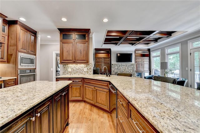 10020 Normandy Ln, Suwanee, GA 30024 - kitchen featuring appliances with stainless steel finishes, stacked washer / drying machine, light wood-style flooring, light stone counters, and recessed lighting