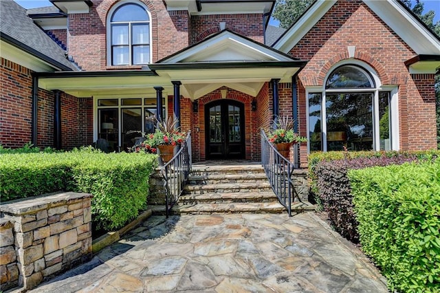 10020 Normandy Ln, Suwanee, GA 30024 - entrance to property featuring french doors, brick siding, and covered porch