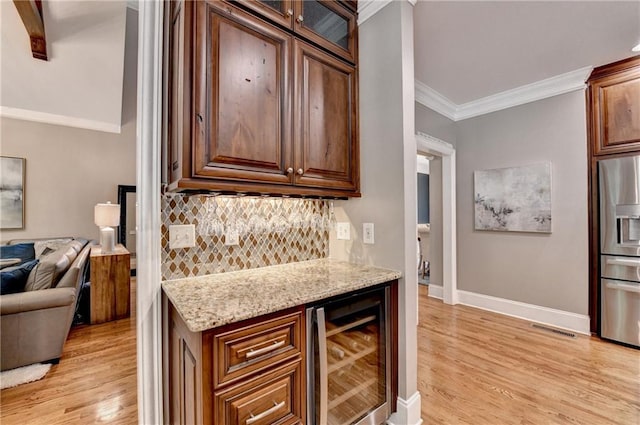 10020 Normandy Ln, Suwanee, GA 30024 - kitchen with wine cooler, stainless steel refrigerator with ice dispenser, light wood-style flooring, crown molding, and tasteful backsplash