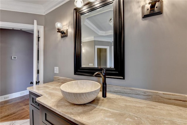10020 Normandy Ln, Suwanee, GA 30024 - bathroom with ornamental molding, vanity, and wood finished floors