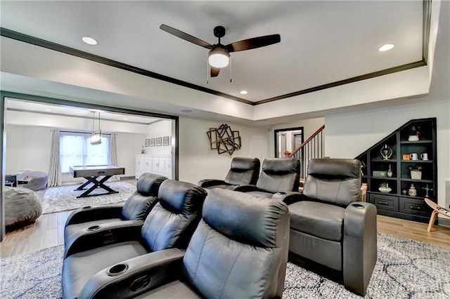 10020 Normandy Ln, Suwanee, GA 30024 - home theater room with ceiling fan, ornamental molding, light wood finished floors, a raised ceiling, and recessed lighting