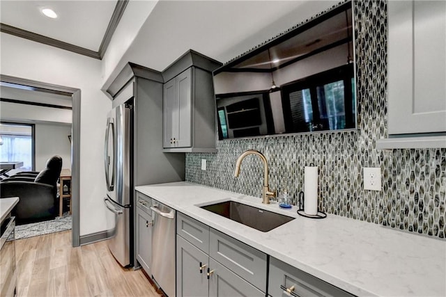 10020 Normandy Ln, Suwanee, GA 30024 - kitchen featuring gray cabinetry, stainless steel appliances, crown molding, light wood finished floors, and light stone countertops