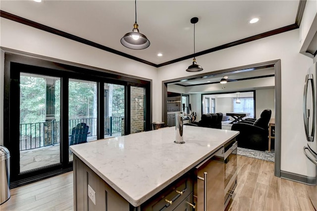 10020 Normandy Ln, Suwanee, GA 30024 - kitchen featuring light stone counters, light wood-style flooring, open floor plan, pendant lighting, and a center island