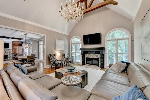 10020 Normandy Ln, Suwanee, GA 30024 - living room with a stone fireplace, lofted ceiling, a chandelier, and wood finished floors