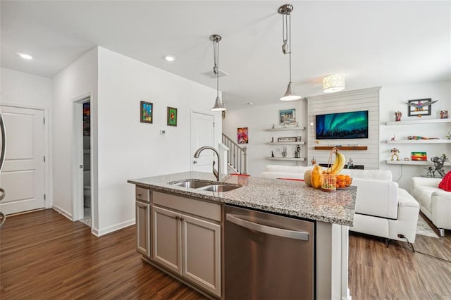 kitchen featuring light stone counters, pendant lighting, sink, dishwasher, and dark hardwood / wood-style flooring