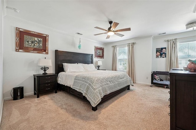 bedroom with ceiling fan, crown molding, and light carpet