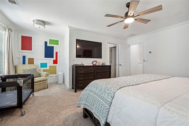 carpeted bedroom featuring ornamental molding and ceiling fan