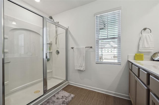 bathroom with walk in shower and vanity