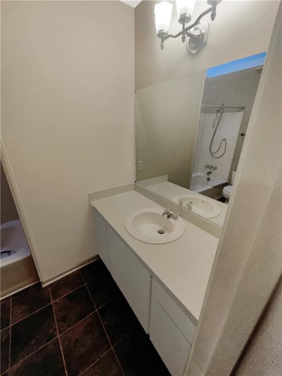 bathroom featuring an inviting chandelier, tile patterned floors, vanity, and shower / bath combination