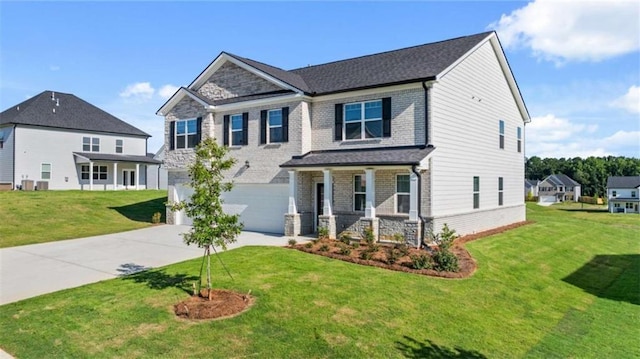 craftsman house featuring a garage, brick siding, driveway, and a front lawn