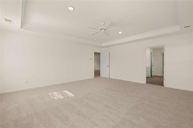 unfurnished room with recessed lighting, carpet flooring, visible vents, baseboards, and a raised ceiling