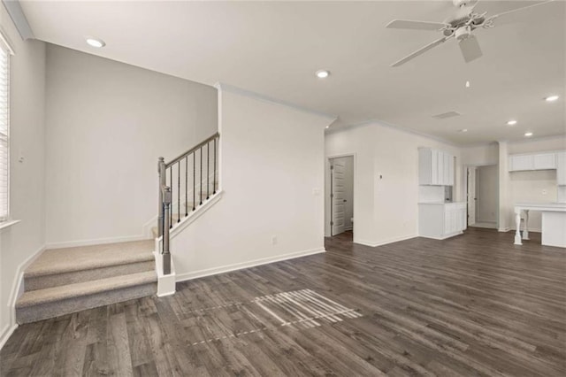 unfurnished living room with dark wood-type flooring, recessed lighting, and stairs