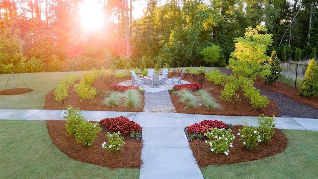 view of yard with an outdoor fire pit, fence, and a patio