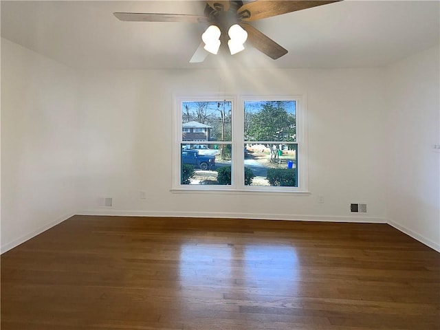 spare room with ceiling fan and dark hardwood / wood-style floors