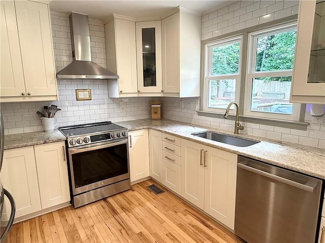 2193 Kildare Way NW, Kennesaw, GA 30152 - kitchen with stainless steel appliances, wall chimney exhaust hood, a sink, backsplash, and light stone countertops