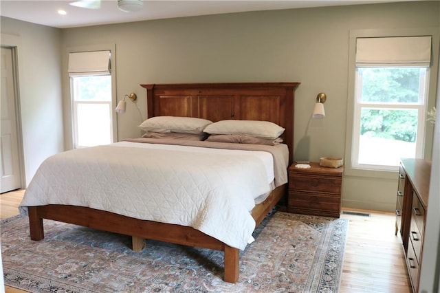 2193 Kildare Way NW, Kennesaw, GA 30152 - bedroom featuring multiple windows, light wood finished floors, and a ceiling fan