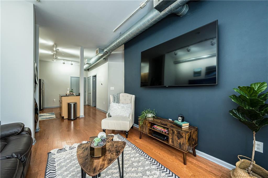 5300 Peachtree Rd Unit 503, Atlanta, GA 30341 - living room with track lighting, wood finished floors, and baseboards