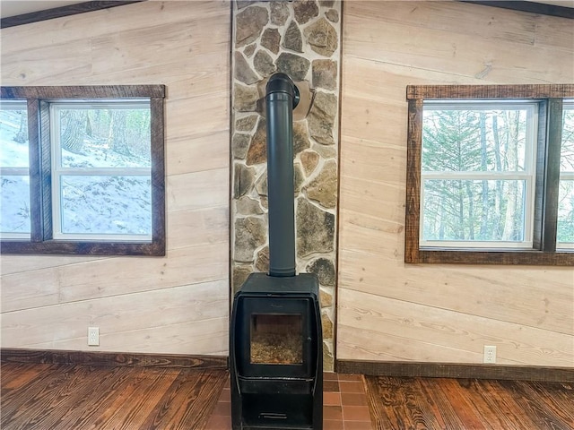interior details featuring wooden walls and a wood stove