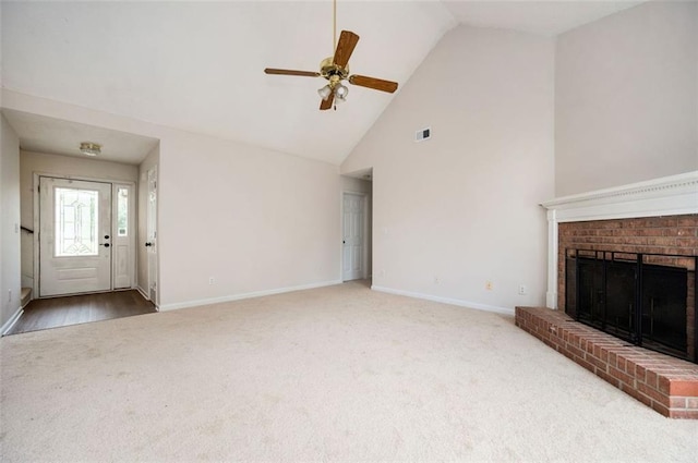 409 Cold Springs Ln, Mcdonough, GA 30252 - unfurnished living room featuring carpet flooring, baseboards, ceiling fan, high vaulted ceiling, and a brick fireplace