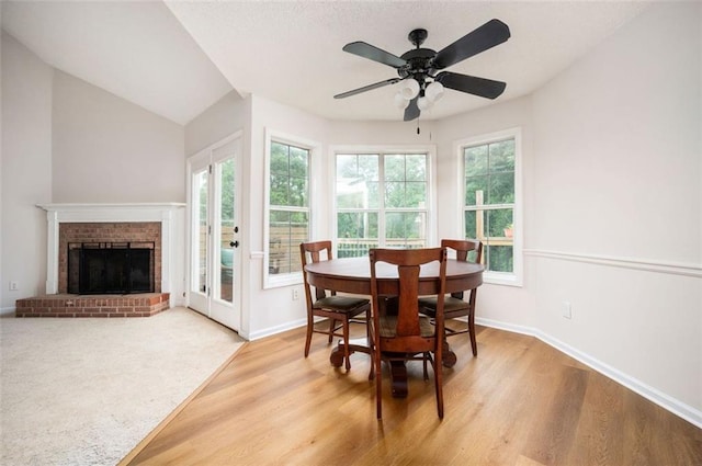 409 Cold Springs Ln, Mcdonough, GA 30252 - dining space featuring light wood-style flooring, a fireplace, and baseboards