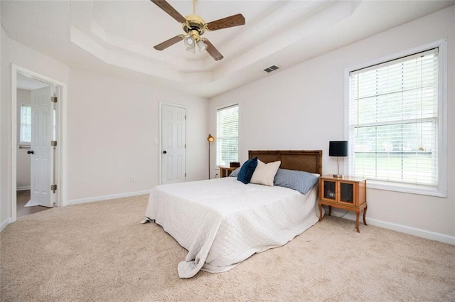 409 Cold Springs Ln, Mcdonough, GA 30252 - carpeted bedroom with a tray ceiling, baseboards, and ceiling fan