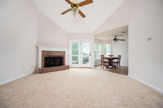 409 Cold Springs Ln, Mcdonough, GA 30252 - carpeted living area featuring ceiling fan, high vaulted ceiling, baseboards, and a fireplace