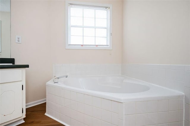 409 Cold Springs Ln, Mcdonough, GA 30252 - bathroom with vanity, a garden tub, and wood finished floors