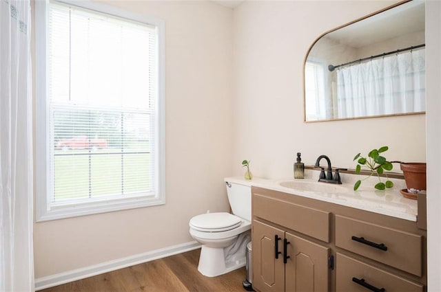 409 Cold Springs Ln, Mcdonough, GA 30252 - full bath featuring toilet, vanity, baseboards, wood finished floors, and a shower with curtain