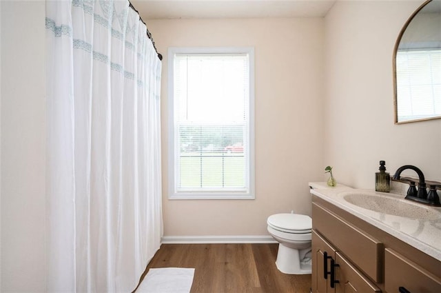 409 Cold Springs Ln, Mcdonough, GA 30252 - bathroom with toilet, vanity, wood finished floors, and baseboards