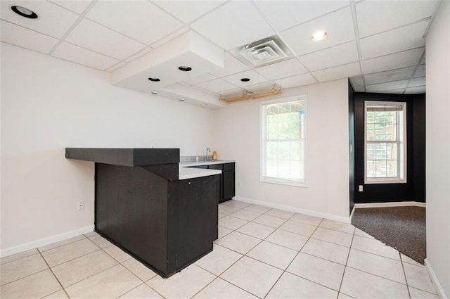 409 Cold Springs Ln, Mcdonough, GA 30252 - kitchen featuring a drop ceiling, a sink, dark cabinetry, and baseboards