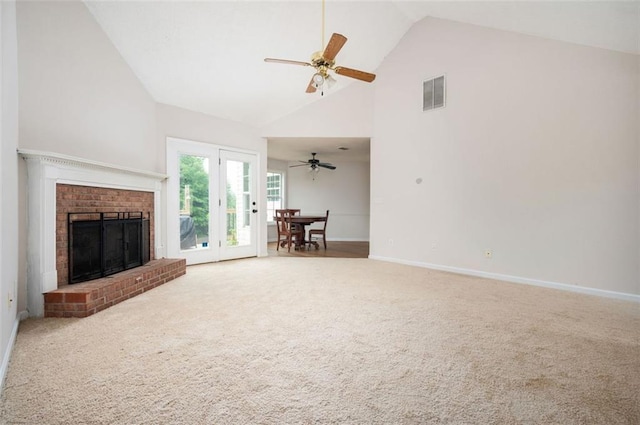 409 Cold Springs Ln, Mcdonough, GA 30252 - carpeted living room with high vaulted ceiling, baseboards, a ceiling fan, and a brick fireplace