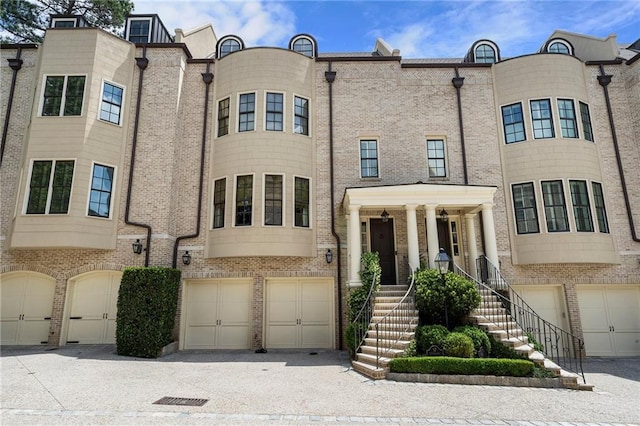 122 Old Ivy Rd NE Unit 17, Atlanta, GA 30342 - view of front facade with a garage and brick siding