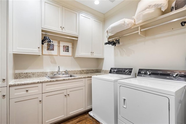 122 Old Ivy Rd NE Unit 17, Atlanta, GA 30342 - washroom featuring washing machine and clothes dryer, cabinet space, and dark wood-type flooring