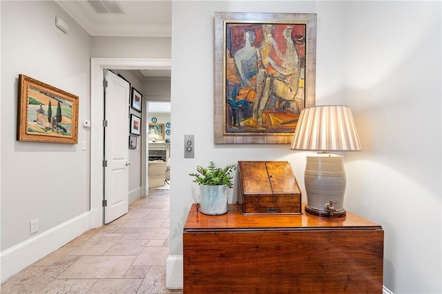 122 Old Ivy Rd NE Unit 17, Atlanta, GA 30342 - hall featuring baseboards, ornamental molding, and stone tile flooring