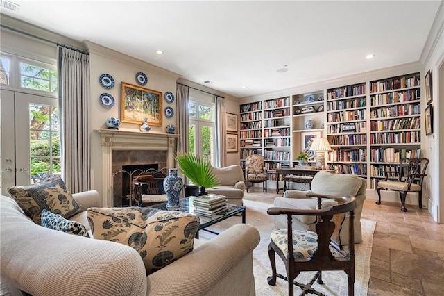 122 Old Ivy Rd NE Unit 17, Atlanta, GA 30342 - sitting room featuring stone tile flooring, ornamental molding, recessed lighting, built in shelves, and a premium fireplace