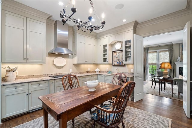 122 Old Ivy Rd NE Unit 17, Atlanta, GA 30342 - dining room with a chandelier, dark wood-style flooring, ornamental molding, recessed lighting, and a fireplace