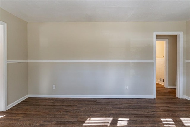 unfurnished room with dark hardwood / wood-style flooring