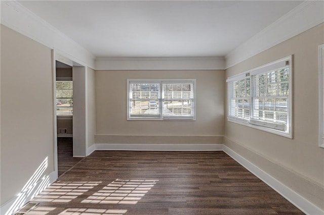 unfurnished room featuring ornamental molding and dark wood-type flooring