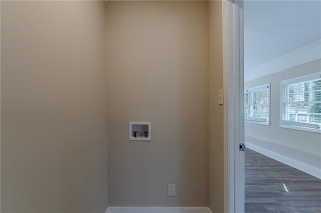 clothes washing area with washer hookup, ornamental molding, and dark wood-type flooring