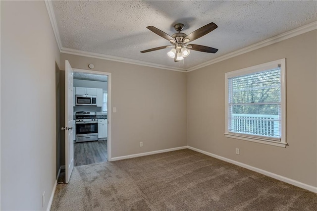 carpeted empty room with ceiling fan, a textured ceiling, and ornamental molding