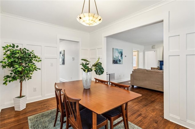 dining space featuring ornamental molding and dark wood-type flooring